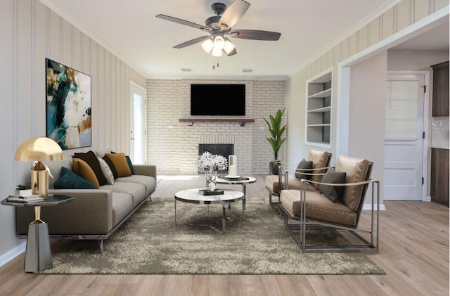 5153 Helene Rd, Memphis, TN 38117 - living area featuring ornamental molding, built in shelves, wood finished floors, a fireplace, and ceiling fan