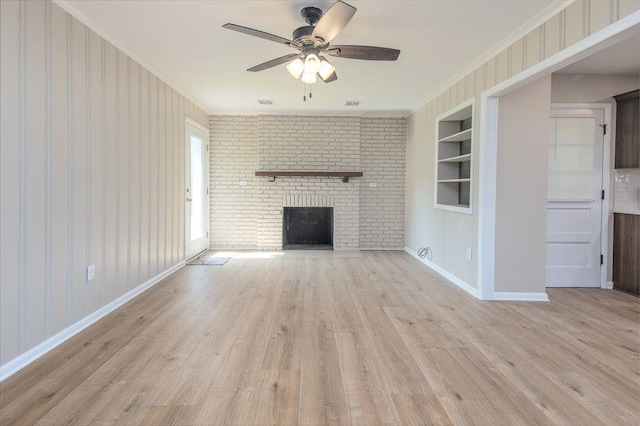 5153 Helene Rd, Memphis, TN 38117 - unfurnished living room with built in features, a ceiling fan, light wood finished floors, a fireplace, and ornamental molding