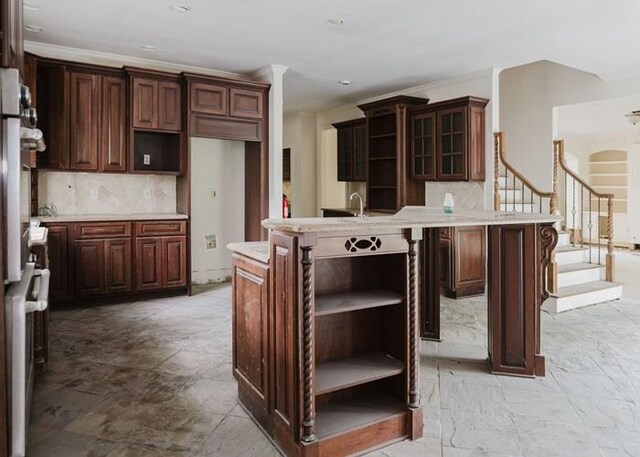 9219 Beaver Valley Ln, Cordova, TN 38018 - kitchen with open shelves, tasteful backsplash, light countertops, glass insert cabinets, and crown molding