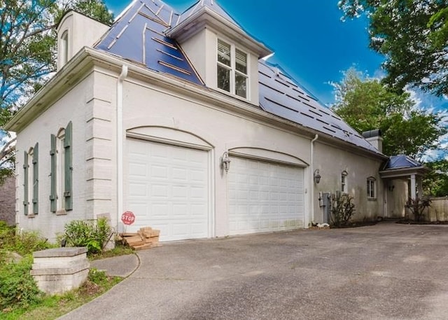 9219 Beaver Valley Ln, Cordova, TN 38018 - view of side of home with driveway, an attached garage, and stucco siding