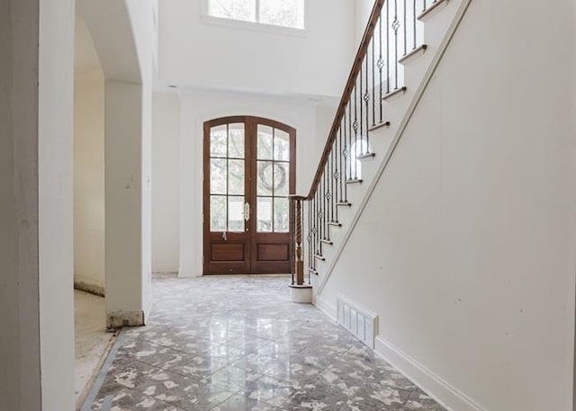 9219 Beaver Valley Ln, Cordova, TN 38018 - entrance foyer featuring arched walkways, plenty of natural light, french doors, a high ceiling, and stairway
