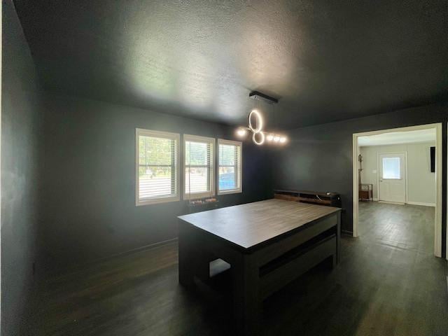 2470 S Flowering Tree Cv, Bartlett, TN 38134 - game room with dark wood-style floors, a textured ceiling, and a chandelier