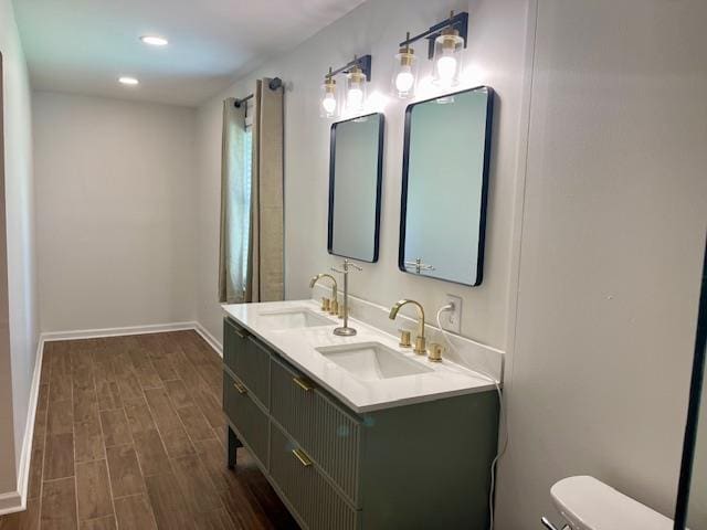 2470 S Flowering Tree Cv, Bartlett, TN 38134 - bathroom featuring wood finished floors, double vanity, and recessed lighting