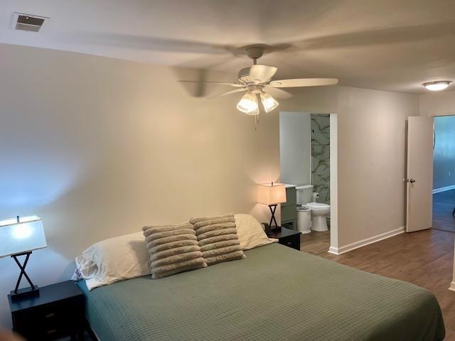 2470 S Flowering Tree Cv, Bartlett, TN 38134 - bedroom featuring wood finished floors, a ceiling fan, and ensuite bath