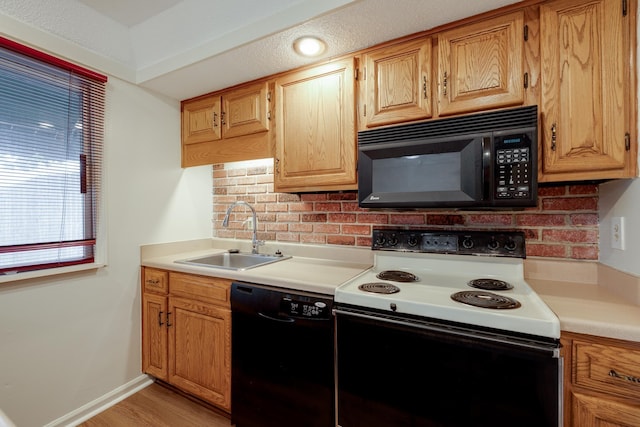 1204 Chamberlain Dr Unit 10, Memphis, TN 38119 - kitchen featuring black appliances, decorative backsplash, light countertops, and light wood-style flooring