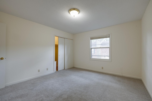 1204 Chamberlain Dr Unit 10, Memphis, TN 38119 - unfurnished bedroom with light carpet, a closet, and a textured ceiling