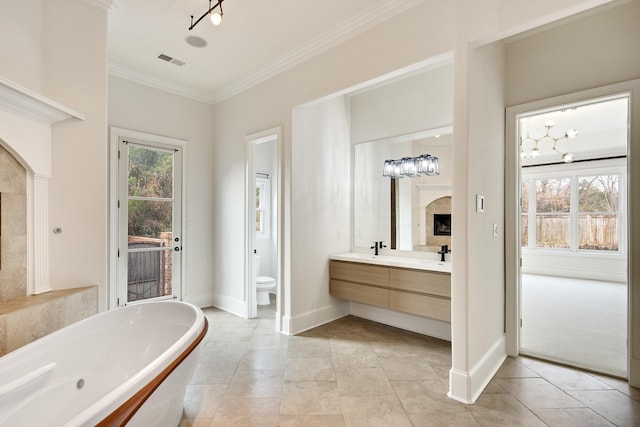 3217 Pointe Hill Cv, Memphis, TN 38125 - bathroom with a freestanding tub, double vanity, crown molding, and tile patterned floors
