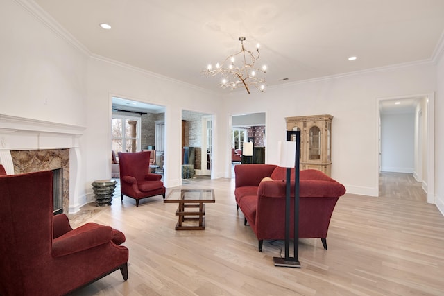 3217 Pointe Hill Cv, Memphis, TN 38125 - living area with light wood-type flooring, a chandelier, a fireplace, ornamental molding, and recessed lighting