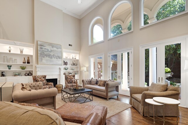 1426 Le Fleur Pl, Memphis, TN 38120 - living room with a high ceiling, crown molding, wood finished floors, and a fireplace