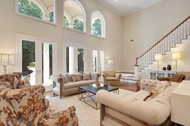 1426 Le Fleur Pl, Memphis, TN 38120 - living area featuring wood finished floors, a high ceiling, stairway, ornamental molding, and french doors
