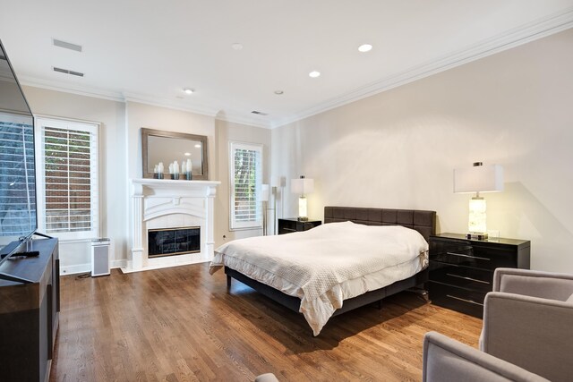 1426 Le Fleur Pl, Memphis, TN 38120 - bedroom featuring wood finished floors, crown molding, a glass covered fireplace, and recessed lighting