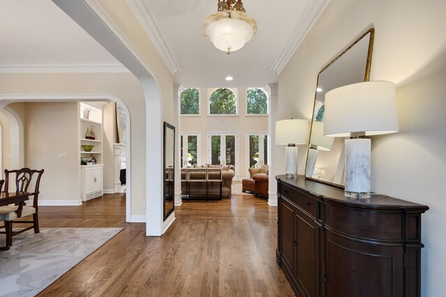 1426 Le Fleur Pl, Memphis, TN 38120 - foyer featuring arched walkways, crown molding, and wood finished floors