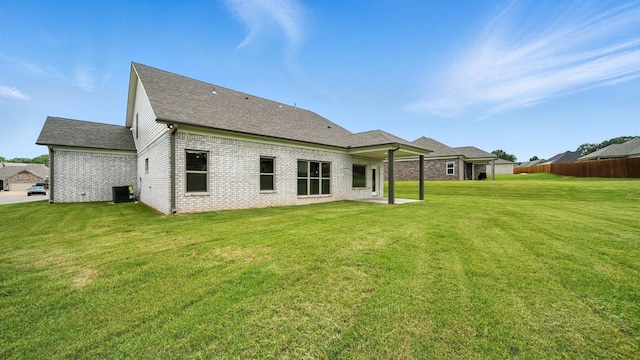 131 Pritchett Cv, Munford, TN 38058 - back of property featuring roof with shingles and brick siding