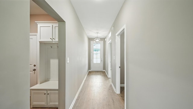 131 Pritchett Cv, Munford, TN 38058 - hallway with light wood finished floors and a chandelier