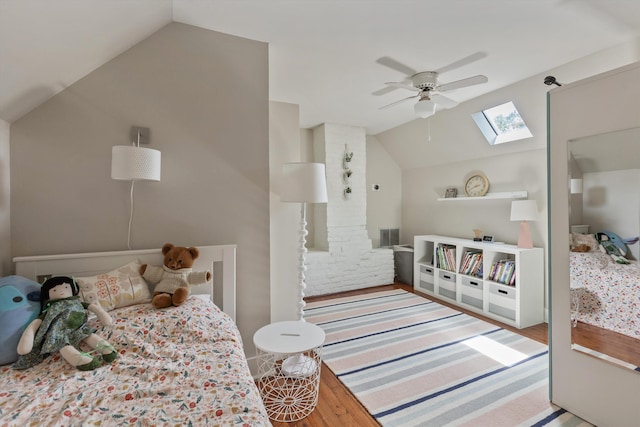 2198 Harbert Ave, Memphis, TN 38104 - bedroom with vaulted ceiling, a skylight, wood finished floors, and ceiling fan