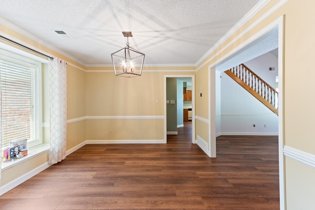 1504 Teal Wing Ln, Memphis, TN 38016 - unfurnished dining area featuring a chandelier, wood finished floors, a textured ceiling, stairs, and crown molding