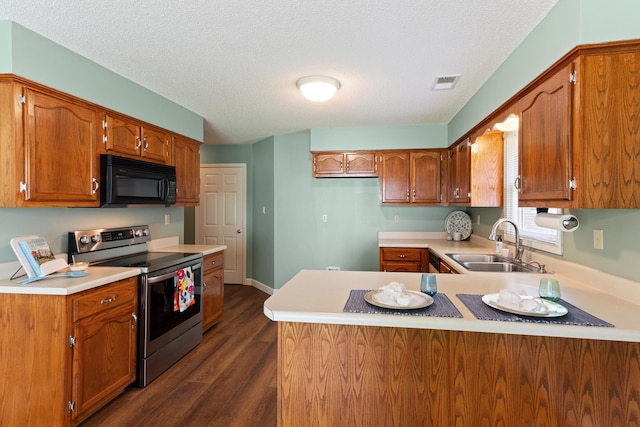 1504 Teal Wing Ln, Memphis, TN 38016 - kitchen featuring black microwave, stainless steel electric range oven, a peninsula, dark wood finished floors, and light countertops