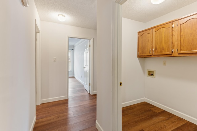 1504 Teal Wing Ln, Memphis, TN 38016 - washroom featuring washer hookup, dark wood finished floors, cabinet space, and a textured ceiling