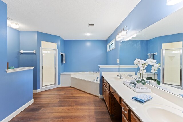 1504 Teal Wing Ln, Memphis, TN 38016 - full bath with a shower stall, a garden tub, double vanity, and wood finished floors