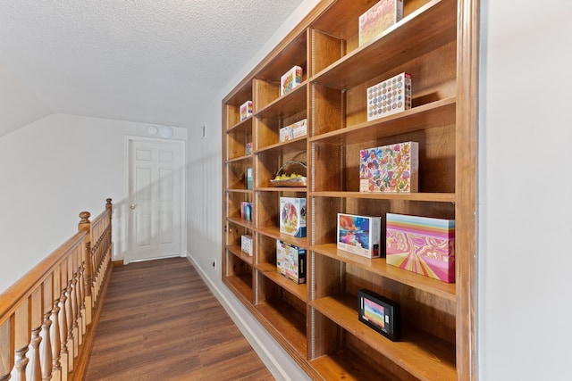 1504 Teal Wing Ln, Memphis, TN 38016 - hallway featuring dark wood-type flooring, a textured ceiling, and vaulted ceiling