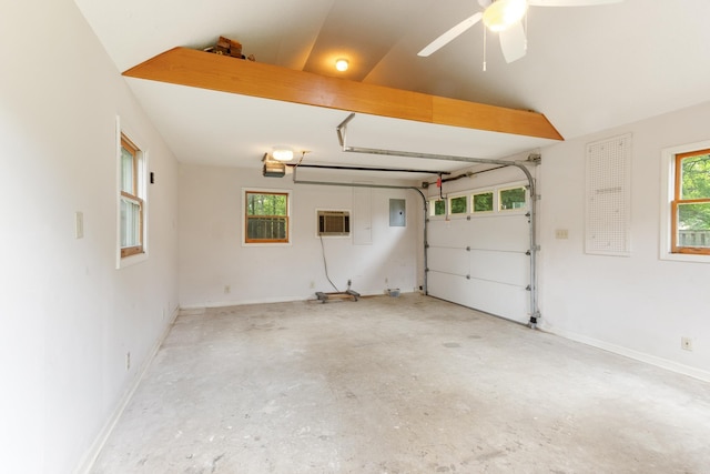 1504 Teal Wing Ln, Memphis, TN 38016 - garage featuring electric panel, a garage door opener, a ceiling fan, and a wall mounted air conditioner