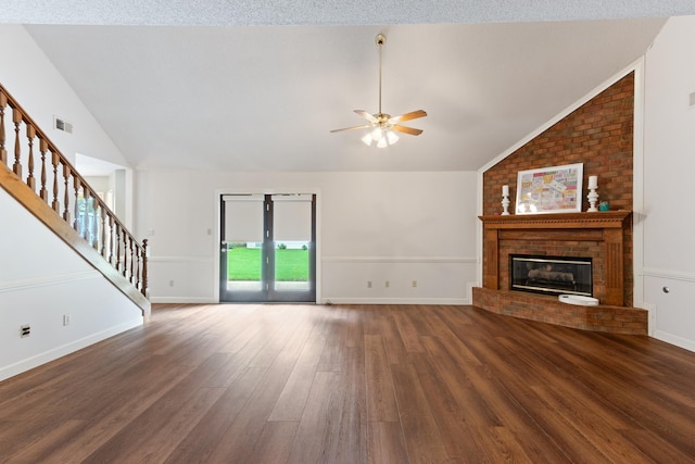 1504 Teal Wing Ln, Memphis, TN 38016 - unfurnished living room featuring lofted ceiling, stairway, wood finished floors, ceiling fan, and a fireplace