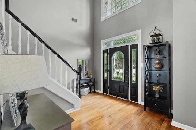 1775 Lisson Cv, Collierville, TN 38017 - entryway with stairs, a towering ceiling, and wood finished floors