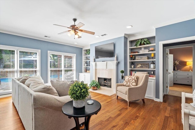 1775 Lisson Cv, Collierville, TN 38017 - living room with ceiling fan, ornamental molding, wood finished floors, built in features, and a high end fireplace