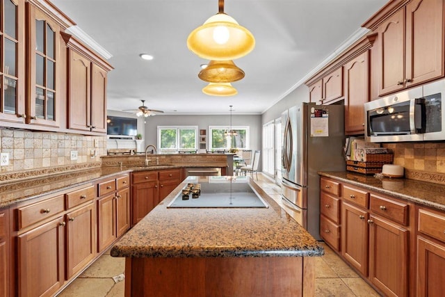 1775 Lisson Cv, Collierville, TN 38017 - kitchen with appliances with stainless steel finishes, a center island, backsplash, a ceiling fan, and glass insert cabinets