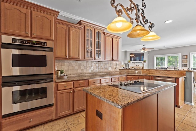 1775 Lisson Cv, Collierville, TN 38017 - kitchen featuring double oven, black electric stovetop, a peninsula, a center island, and light stone countertops