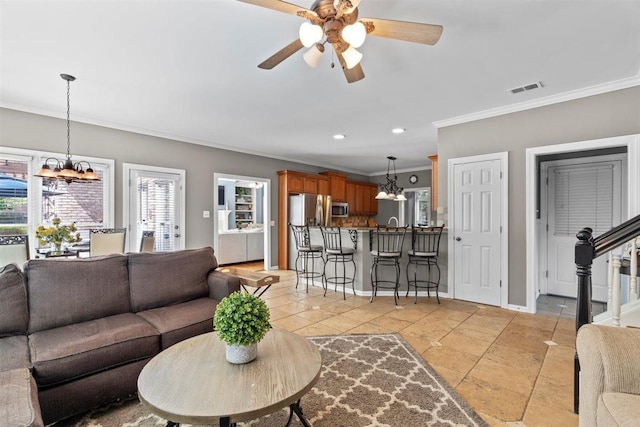 1775 Lisson Cv, Collierville, TN 38017 - living area with ornamental molding, a chandelier, a ceiling fan, and recessed lighting