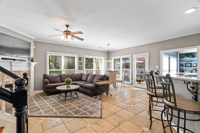 1775 Lisson Cv, Collierville, TN 38017 - living room with a ceiling fan, crown molding, stone tile flooring, and a tiled fireplace