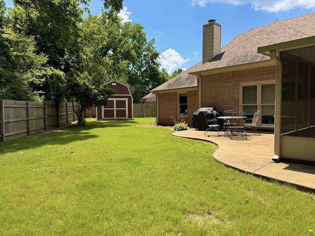 902 Wildbird Cv, Collierville, TN 38017 - fenced backyard featuring a storage shed and a patio area