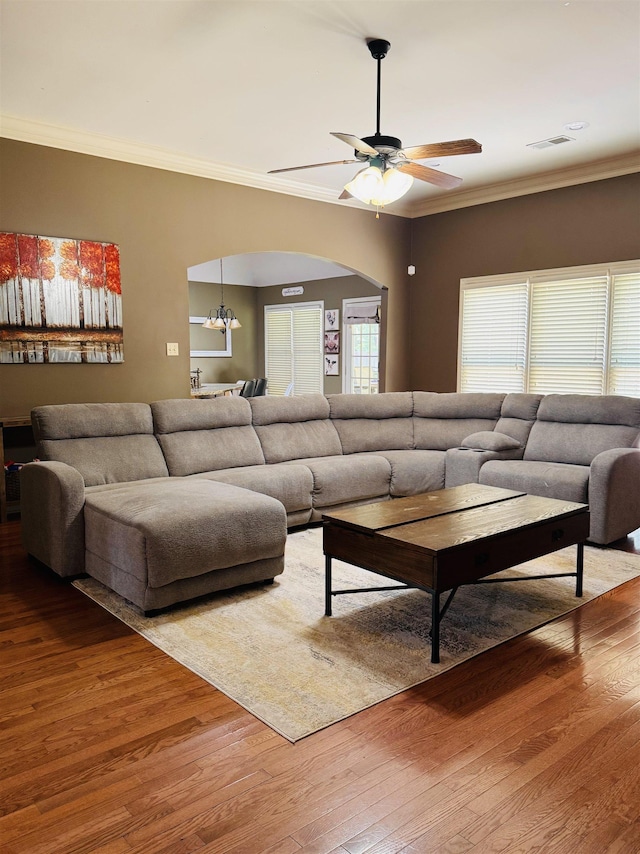 902 Wildbird Cv, Collierville, TN 38017 - living area with arched walkways, ceiling fan, wood finished floors, and ornamental molding