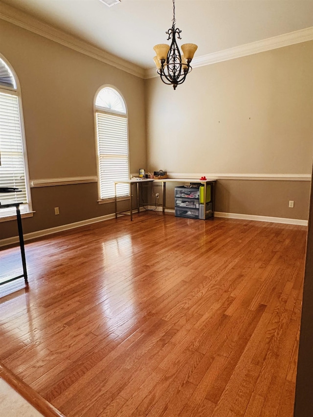 902 Wildbird Cv, Collierville, TN 38017 - unfurnished room with a chandelier, wood finished floors, and ornamental molding