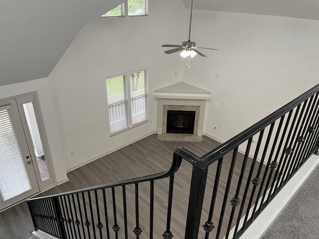 1319 E Island Pl E, Memphis, TN 38103 - staircase with wood finished floors, plenty of natural light, a ceiling fan, a tiled fireplace, and high vaulted ceiling