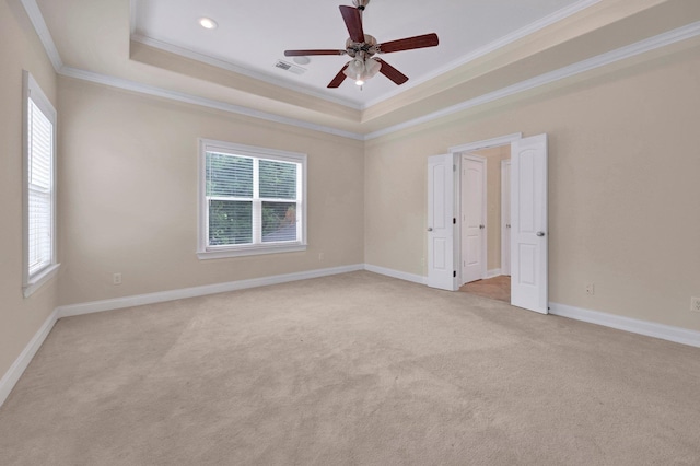 1160 Harbor River Cv, Memphis, TN 38103 - unfurnished room with crown molding, a raised ceiling, plenty of natural light, ceiling fan, and light colored carpet
