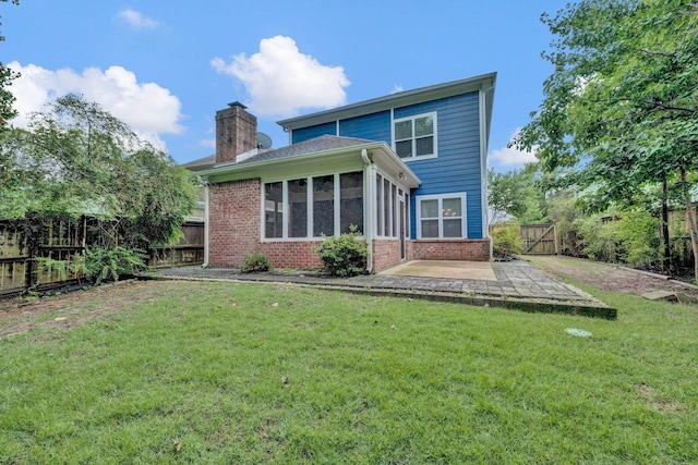 1160 Harbor River Cv, Memphis, TN 38103 - rear view of property featuring brick siding, a patio, a fenced backyard, a chimney, and a sunroom