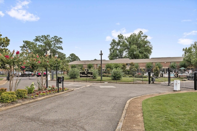 5904 Roxbury Dr, Memphis, TN 38119 - view of asphalt road featuring a gate, a gated entry, and curbs