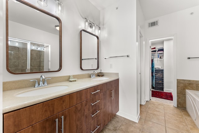 380 N Island Dr Unit 302, Memphis, TN 38103 - full bath featuring a spacious closet, double vanity, a bath, tile patterned flooring, and tiled shower