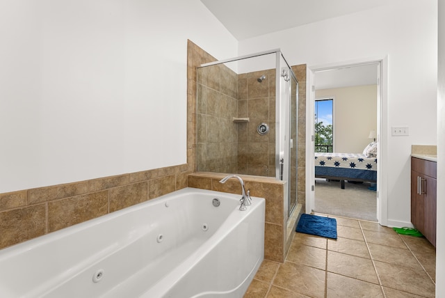 380 N Island Dr Unit 302, Memphis, TN 38103 - bathroom featuring a jetted tub, a stall shower, vanity, ensuite bath, and tile patterned floors