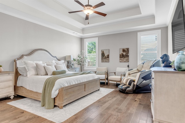 4712 Carousel Ln, Collierville, TN 38017 - bedroom featuring ornamental molding, a tray ceiling, light wood-style flooring, and ceiling fan