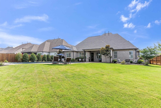 4712 Carousel Ln, Collierville, TN 38017 - back of property with a fenced backyard, a patio area, and brick siding
