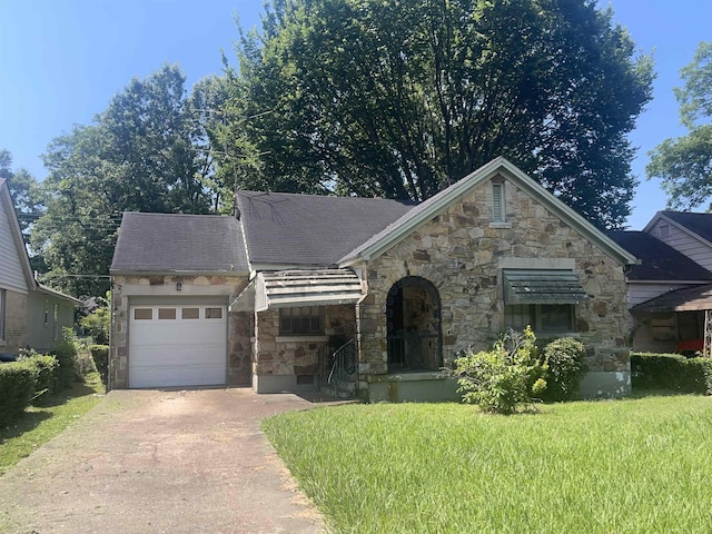 827 E Mallory Ave E, Memphis, TN 38106 - view of front of property with stone siding, driveway, a front lawn, and a garage