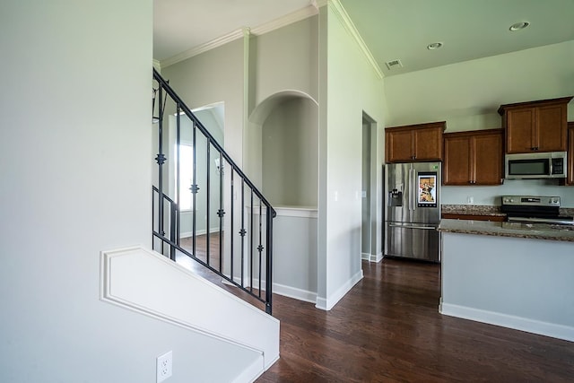 2289 Wellspring Ln, Memphis, TN 38016 - kitchen featuring stainless steel appliances, dark wood-style flooring, crown molding, dark stone counters, and recessed lighting