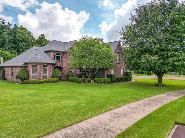 4362 Bridgestone Cir, Bartlett, TN 38135 - view of front of home with brick siding, a front yard, and a shingled roof