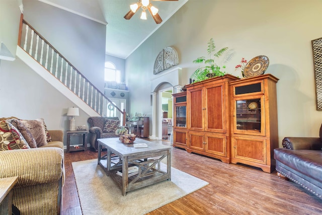 4362 Bridgestone Cir, Bartlett, TN 38135 - living area featuring high vaulted ceiling, a ceiling fan, stairway, light wood-style floors, and arched walkways