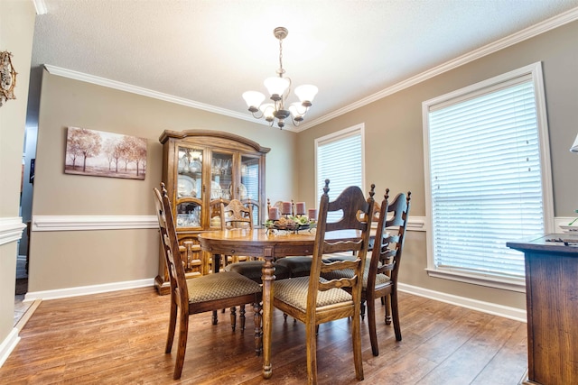 4362 Bridgestone Cir, Bartlett, TN 38135 - dining space featuring a chandelier, light wood finished floors, and ornamental molding