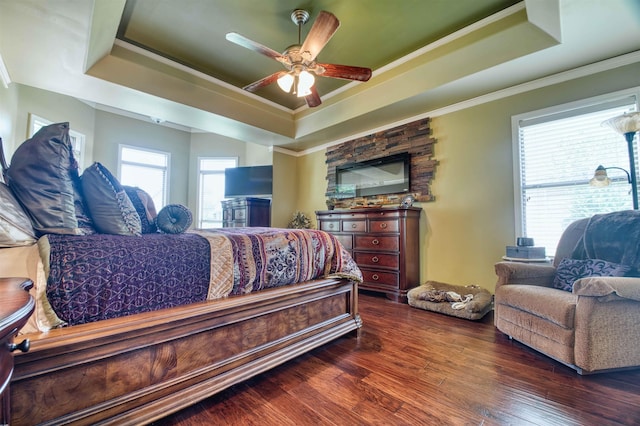 4362 Bridgestone Cir, Bartlett, TN 38135 - bedroom featuring a tray ceiling, dark wood-style flooring, crown molding, and a ceiling fan