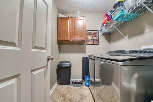4362 Bridgestone Cir, Bartlett, TN 38135 - laundry room with washing machine and dryer, light tile patterned floors, cabinet space, and a textured ceiling